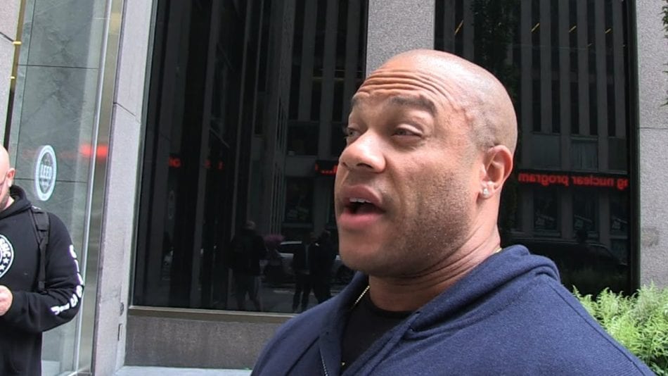 Phil Heath standing in front of a building